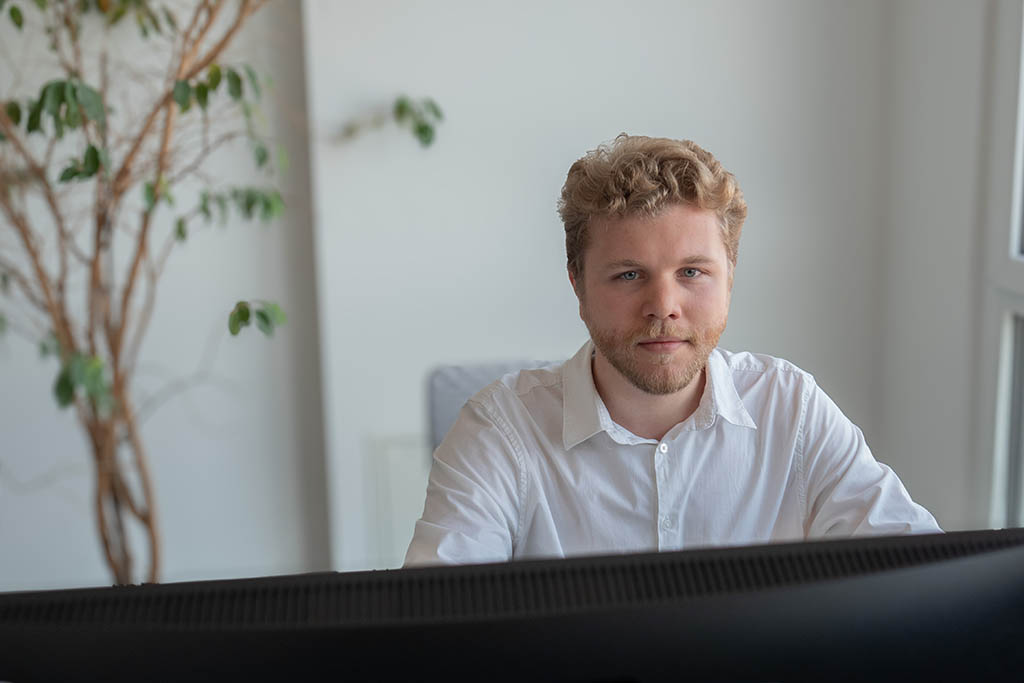 Ilya from STRATEC sitting in front of his desk