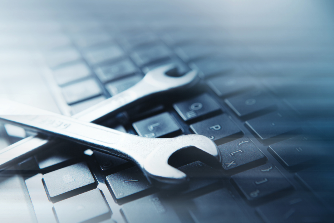 two wrenches on a keyboard