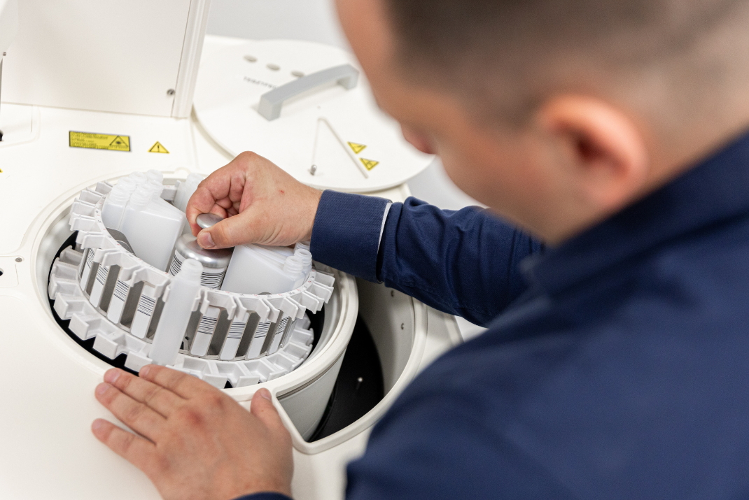 Ádám from Diatron pulling out a testing tube from a Diatron instrumentation