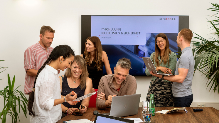 STRATEC employees during a meeting in front of a bigger screen in Austria STRATEC employees during a meeting in front of a bigger screen in Austria