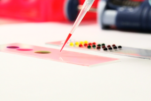 Pipetting of a sample in the laboratory at STRATEC