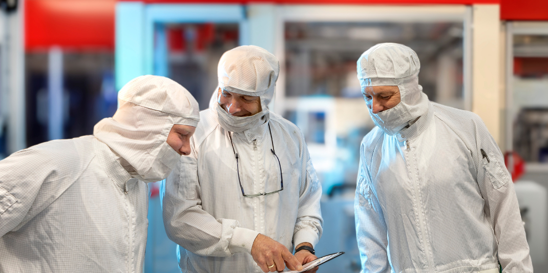 Three laboratorians with safety gear talking about work