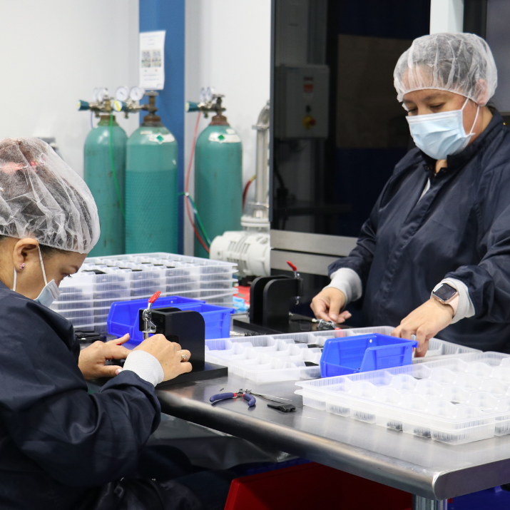 Natech employees with safety hoods and masks preparing the individual components for a Natech system