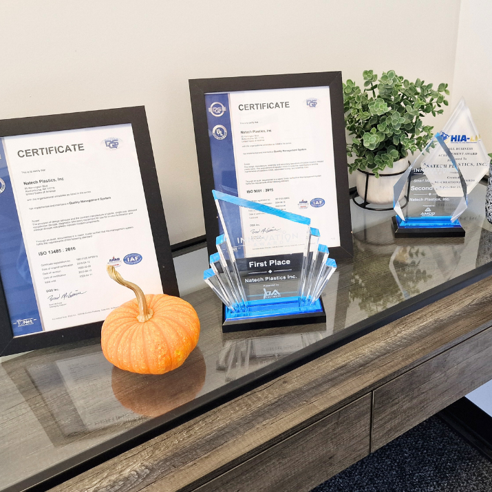 Certifications and awards of Natech placed on a glass wooden table Certifications and awards of Natech placed on a glass wooden table
