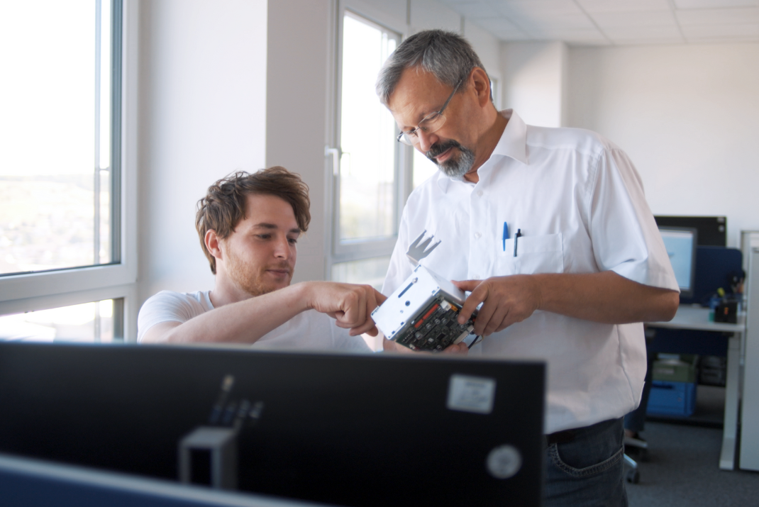 Two STRATEC employees inspecting a module 