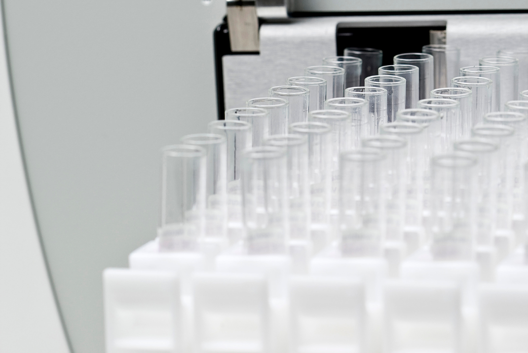 Close-up of several test tubes being put into a laboratory machine at STRATEC