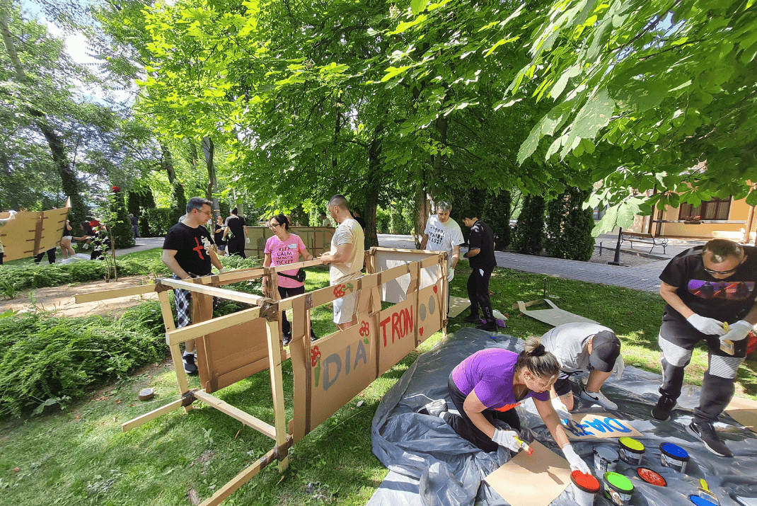 Diatron employees outside painting and building something on a team event 