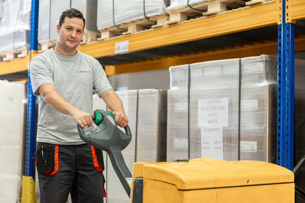 A warehouse clerk using a forklift at Diatron Hungary 