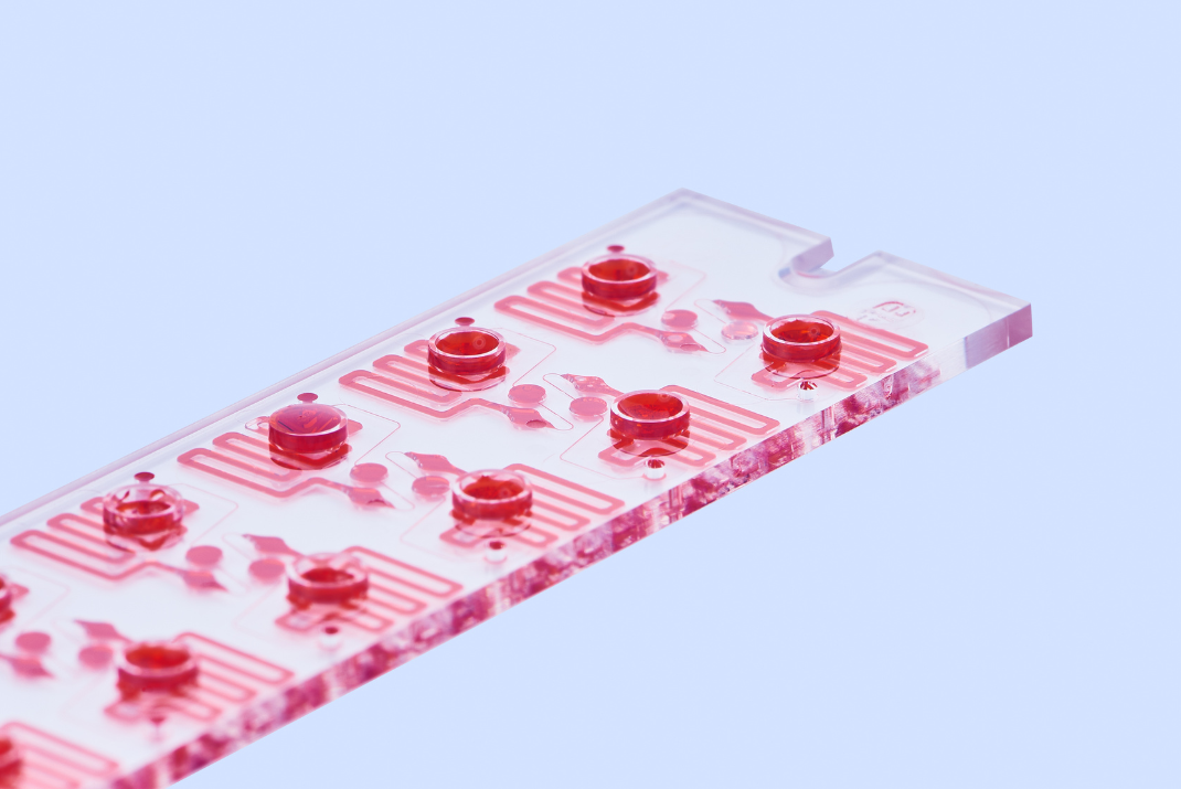 Clear disc with red lines for protein analysis at STRATEC