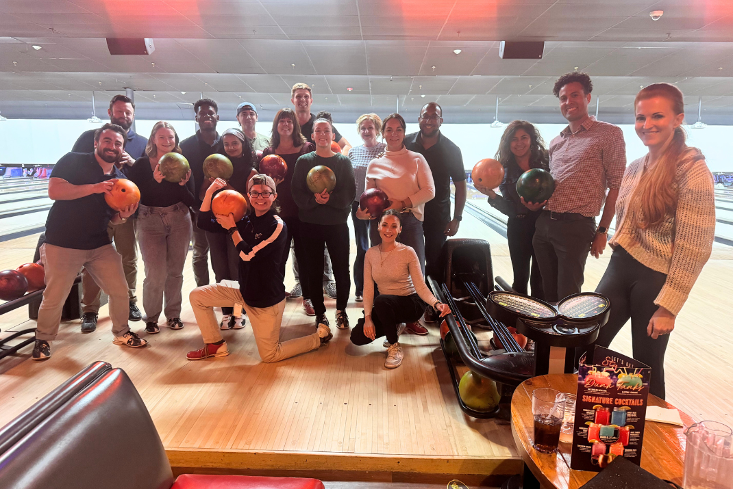 A group selfie of colleagues during a bowling night A group selfie of colleagues during a bowling night